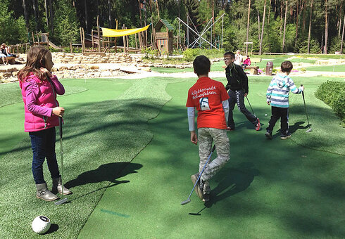 Kinder auf einer AdventureGolfbahn