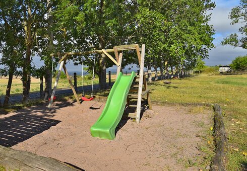 kleiner Spielplatz mit Schaukel und Rutsche